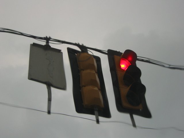 Traffic light through sunroof during rainstorm